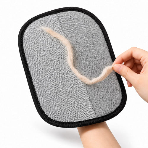 Pet fur being lifted away from the gray cleaning surface of the ShedLess mitt