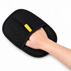 Black mesh back of reusable ShedLess pet hair remover mitt worn on a hand